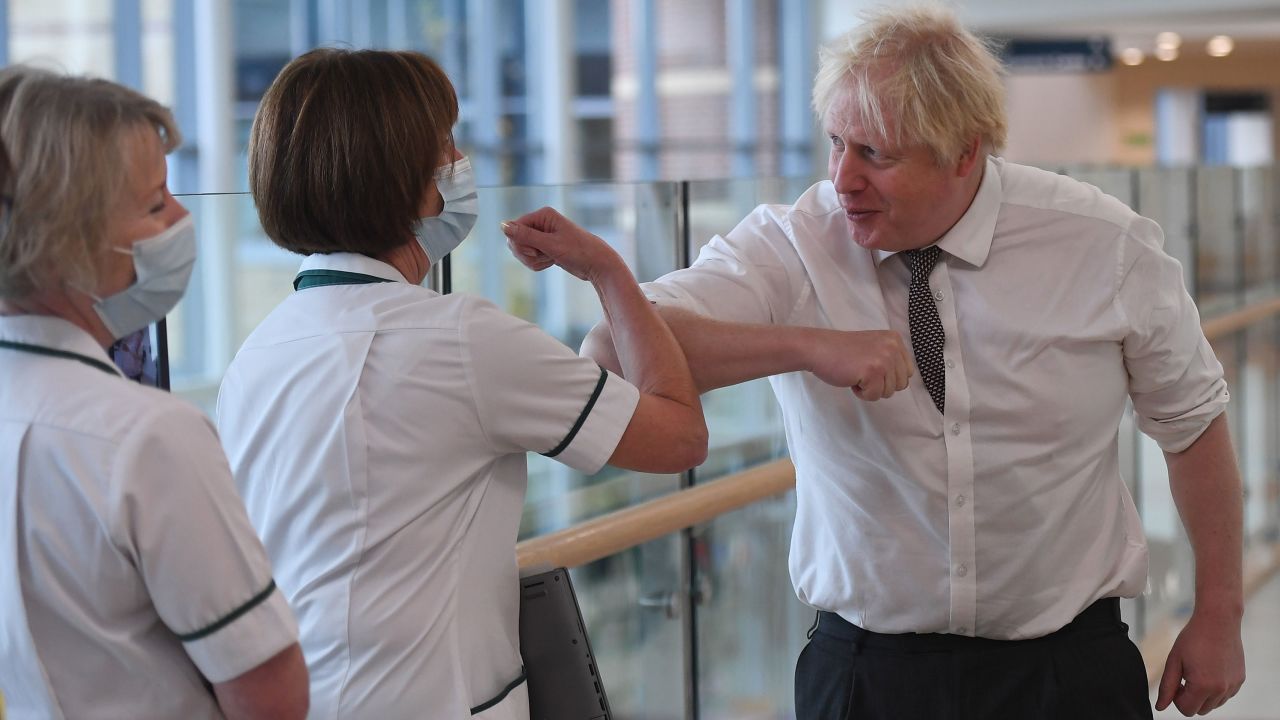 Boris Johnson visits a hospital during the 2021 pandemic. The investigation could embarrass the former prime minister. 