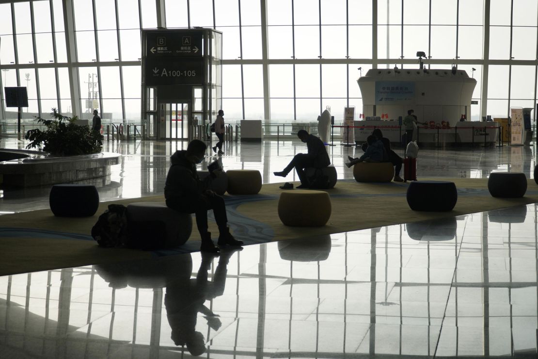 Passengers wait for a flight at Daxing Airport in Beijing on February 8, 2021.