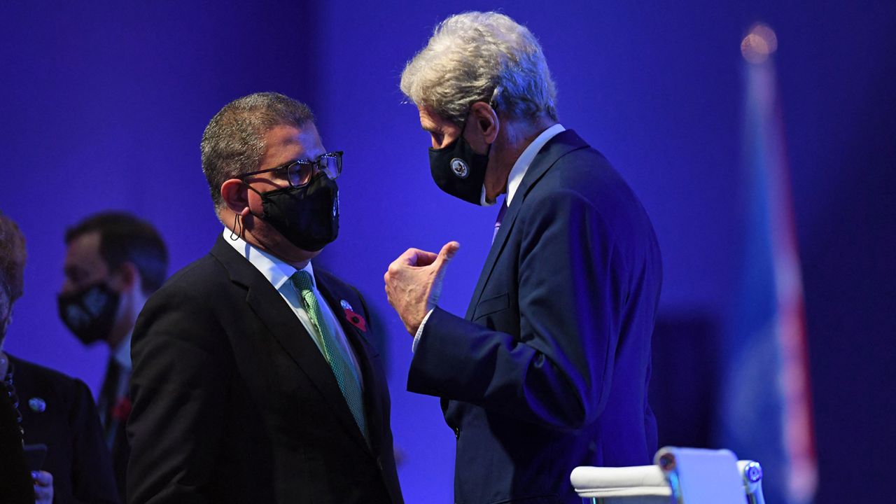 US climate envoy John Kerry, right, speaks with COP26 President Alok Sharma on Saturday at the climate summit.