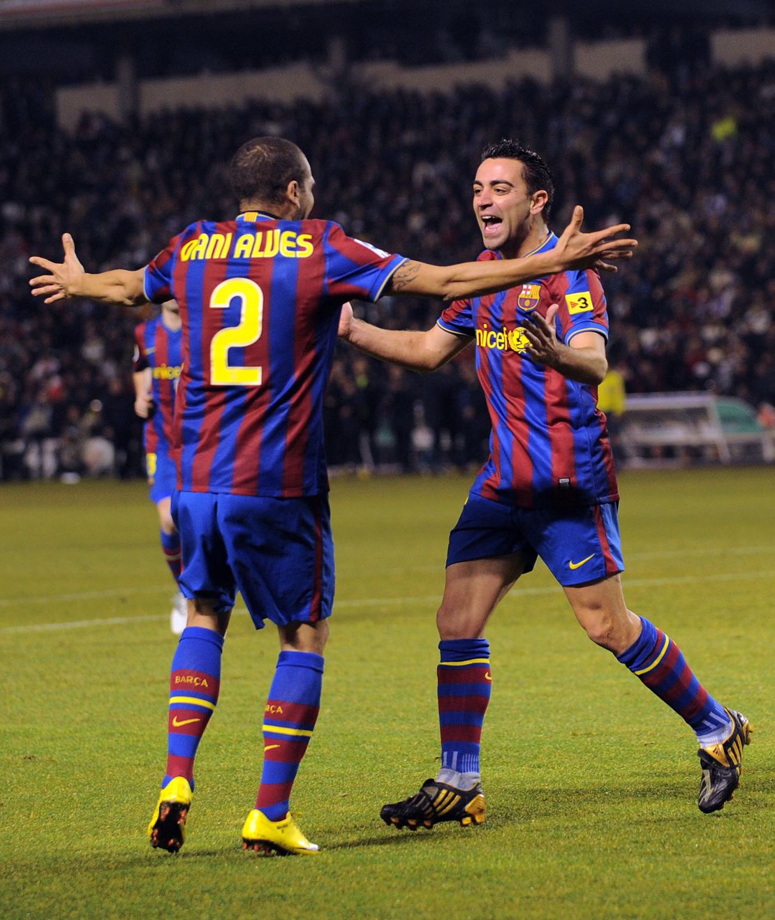 Xavi celebrates with Alves after scoring Barcelona's first goal in the La Liga match between Valladolid and Barcelona on January 23, 2010.