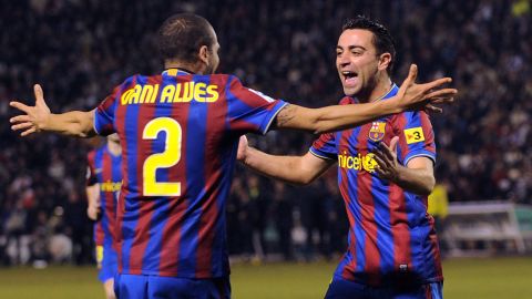 Xavi celebrates with Alves after scoring Barcelona's first goal in the La Liga match between Valladolid and Barcelona on January 23, 2010.