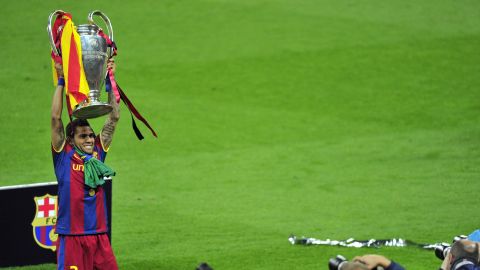 Alves celebrates with the Champions League trophy at Wembley stadium on May 28, 2011.