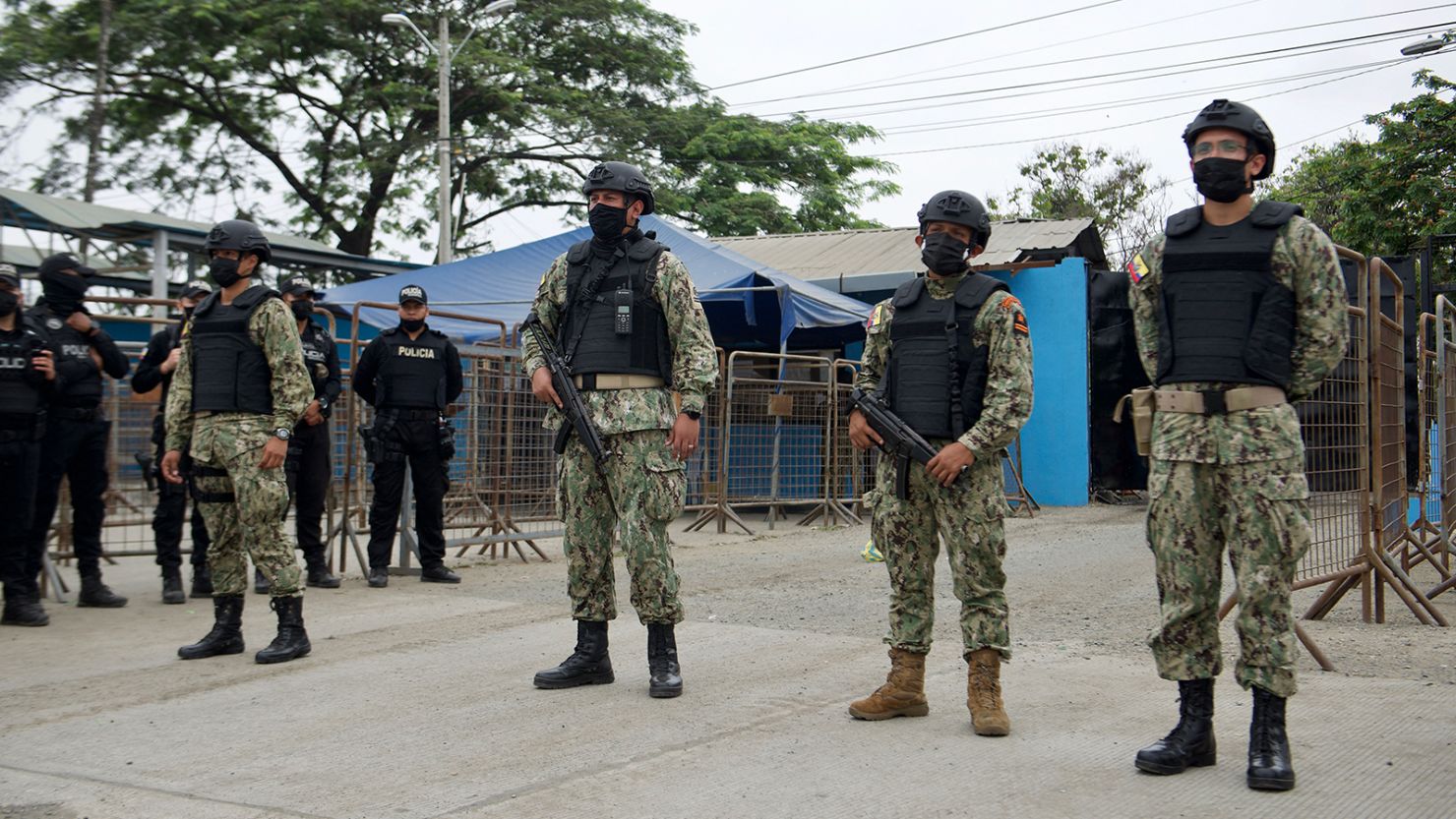 Military police stand guard outside the Guayas 1 prison after a violent outburst between the inmates that left 58 dead in Guayaquil, Ecuador, on November 13, 2021. 