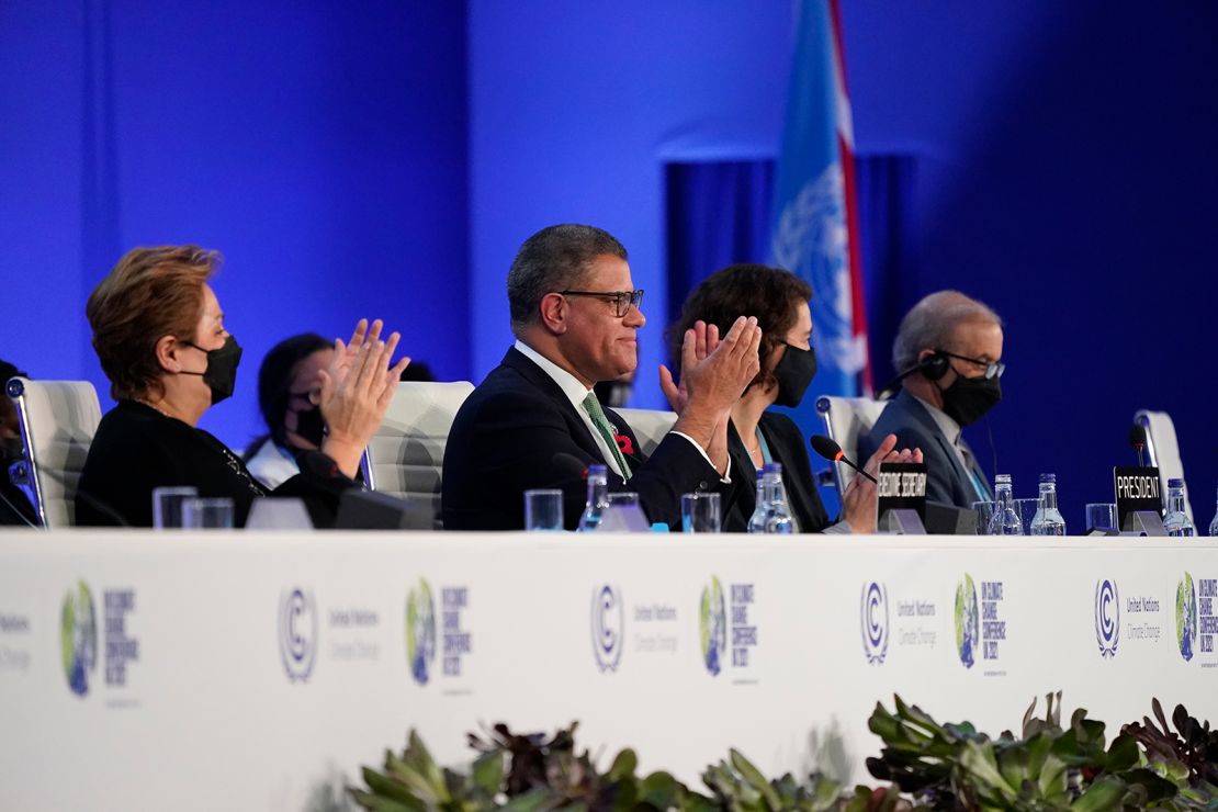 Britain's Alok Sharma, second left, President of the COP26 and Patricia Espinosa, left, UNFCCC Executive-Secretary applaud during the closing plenary session at the COP26 UN Climate Summit, in Glasgow, Scotland, Saturday, Nov. 13, 2021