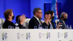 Britain's Alok Sharma, second left, President of the COP26 and Patricia Espinosa, left, UNFCCC Executive-Secretary applaud during the closing plenary session at the COP26 U.N. Climate Summit, in Glasgow, Scotland, Saturday, Nov. 13, 2021. Government negotiators from nearly 200 countries have adopted a new deal on climate action after a last-minute intervention by India to water down the language on cutting emissions from coal.(AP Photo/Alberto Pezzali)