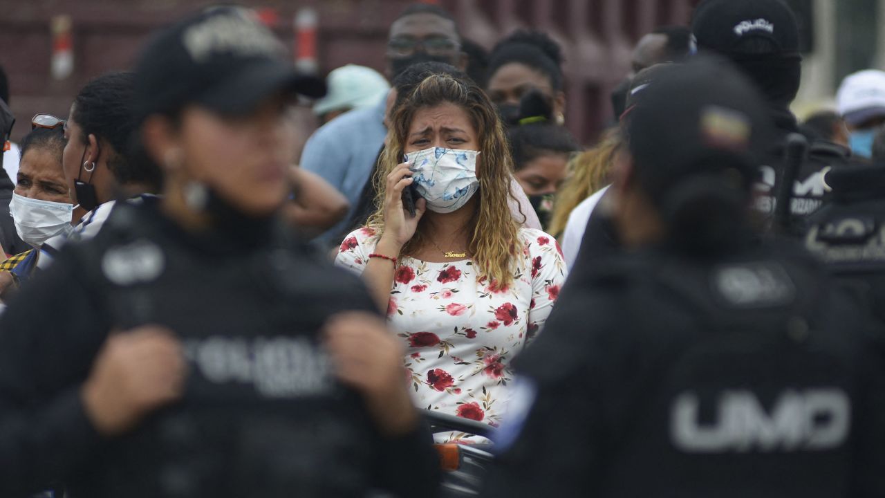A relative of an inmate cries as she waits for news after 58 convicts were killed in a riot at the Guayas 1 prison in Guayaquil on November 13, 2021.