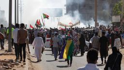 Sudanese opponents of the military coup wave national flags as they take part in a protest in the city of Khartoum North near the capital, on November 13