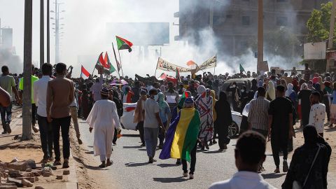 Sudanese opponents of the military coup wave national flags as they take part in a protest in the city of Khartoum North near the capital, on November 13, 2021.