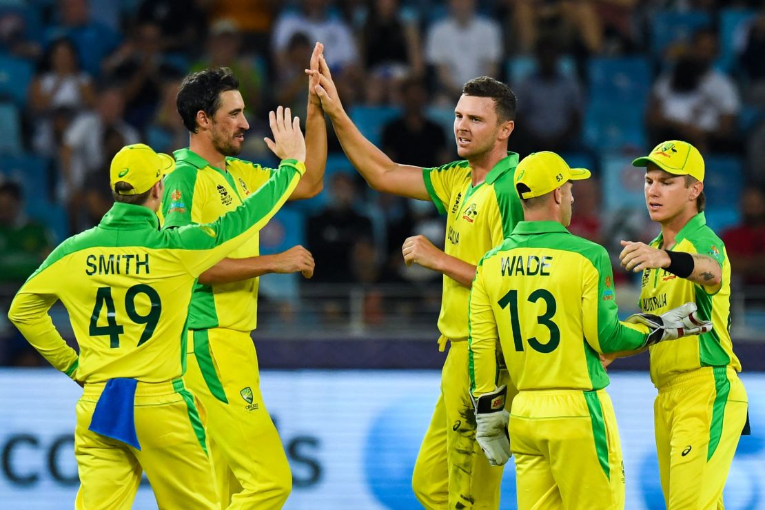 Josh Hazlewood (middle) celebrates with teammates after dismissing New Zealand's Daryl Mitchell during the T20 World Cup final.