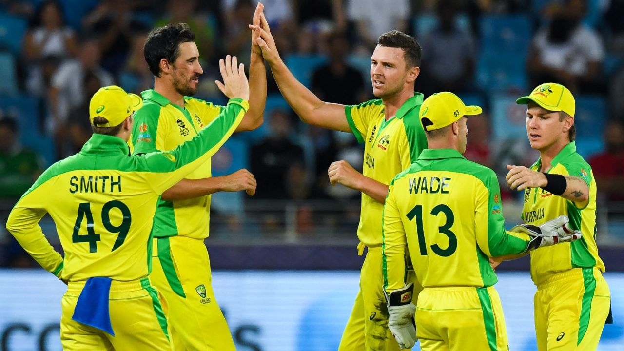 Josh Hazlewood (middle) celebrates with teammates after dismissing New Zealand's Daryl Mitchell during the T20 World Cup final.