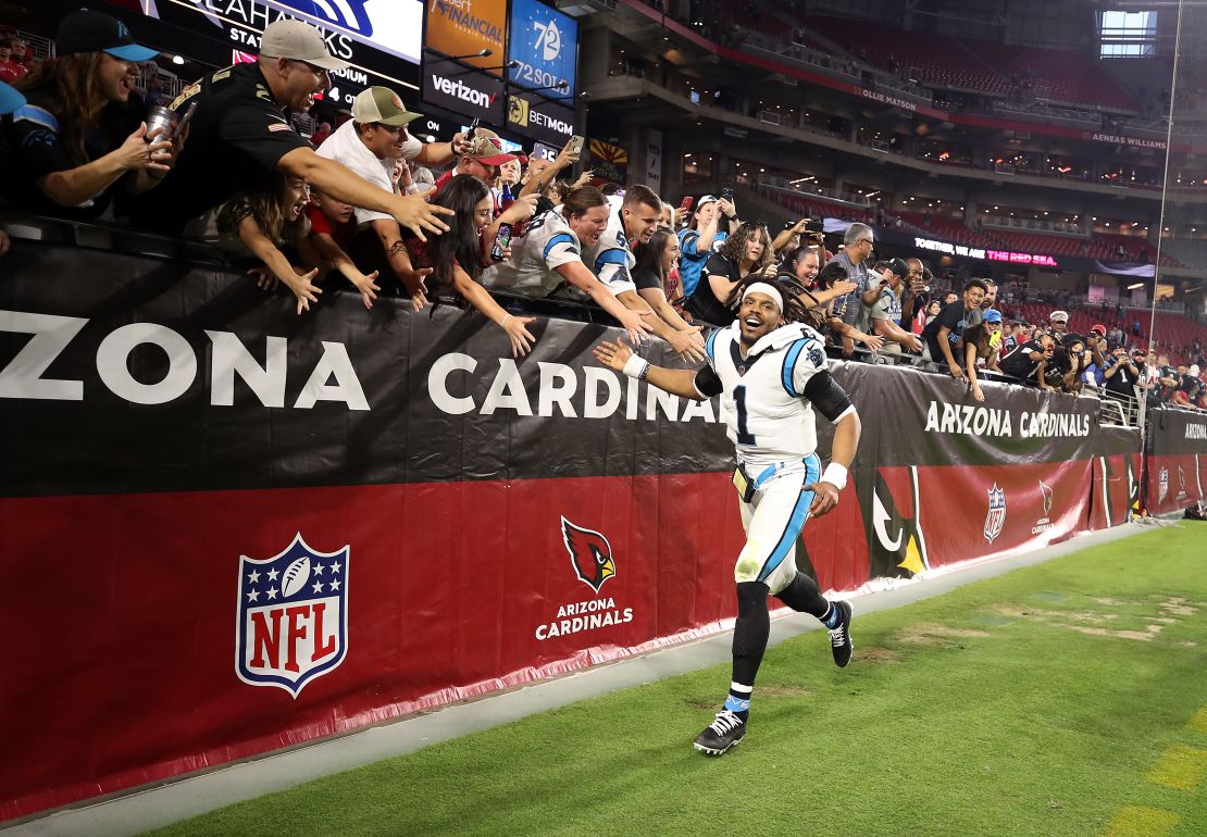 Newton celebrates with fans after  beating the Arizona Cardinals.