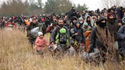 Migrants gather on the Belarusian-Polish border near the Polish border crossing in Kuznica on November 15, 2021. - Thousands of migrants -- most of them from the Middle East -- have crossed or attempted to cross the EU and NATO border since the summer. Western countries have accused the Belarusian regime, which is backed by Russia, of engineering the crisis in retaliation against EU sanctions, charges that Minsk has denied. - Belarus OUT (Photo by Oksana MANCHUK / BELTA / AFP) / Belarus OUT (Photo by OKSANA MANCHUK/BELTA/AFP via Getty Images)