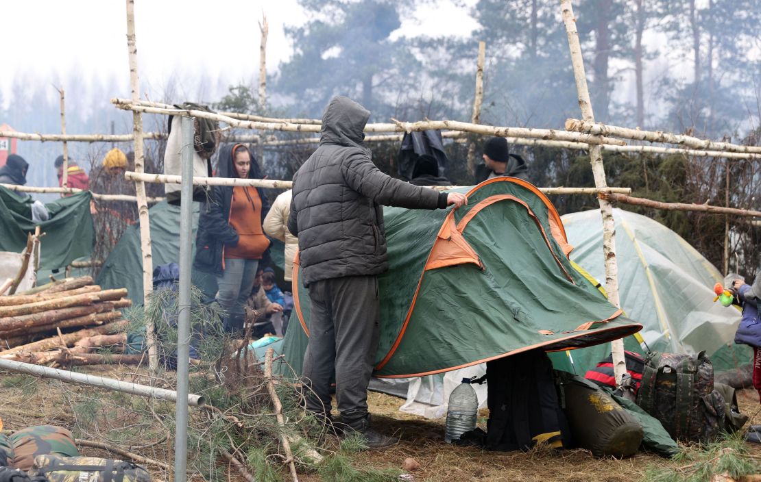 Migrants collect their belongings before leaving a camp on the Belarusian-Polish border in the Grodno region and heading towards the Polish border crossing in Kuznica on November 15.