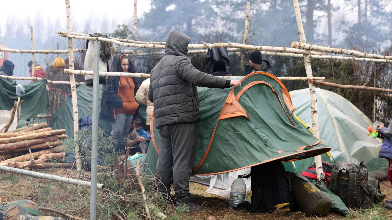 Migrants collect their belongings before leaving a camp on the Belarusian-Polish border in the Grodno region and heading towards the Polish border crossing in Kuznica on November 15.