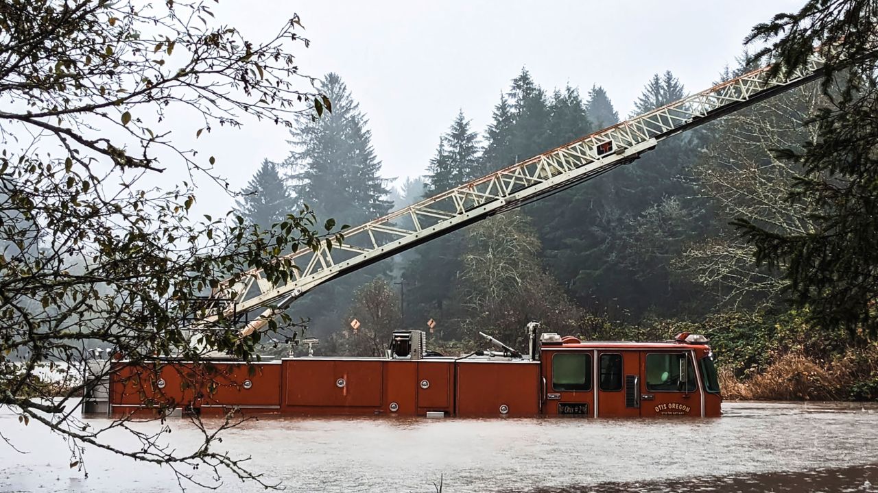 A fire engine is surrounded by rising waters in Oregon. Recent atmospheric river events have also brought heavy rain to parts of Oregon.