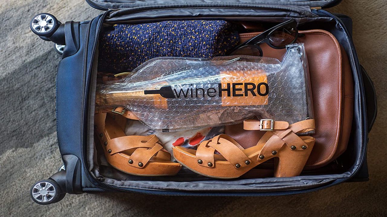 A photo of a bottle of wine inside of a WineHero bottle protector inside of a carry-on bag