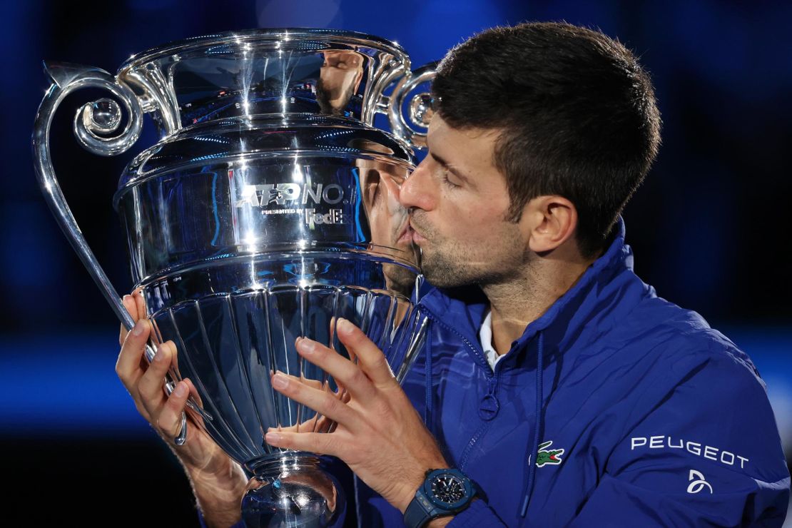 Novak Djokovic is presented with the trophy for ending the year as world No. 1.