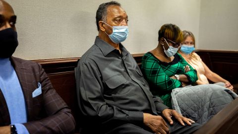 The Rev. Jesse Jackson, center, sits with Ahmaud Arbery's mother, Wanda Cooper-Jones, during the trial of Greg McMichael and his son, Travis McMichael, and a neighbor, William "Roddie" Bryan in the Glynn County Courthouse Monday in Brunswick, Georgia.