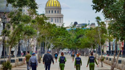 Police officers walk along El Paseo del Prado street in Havana, on November 15, 2021.