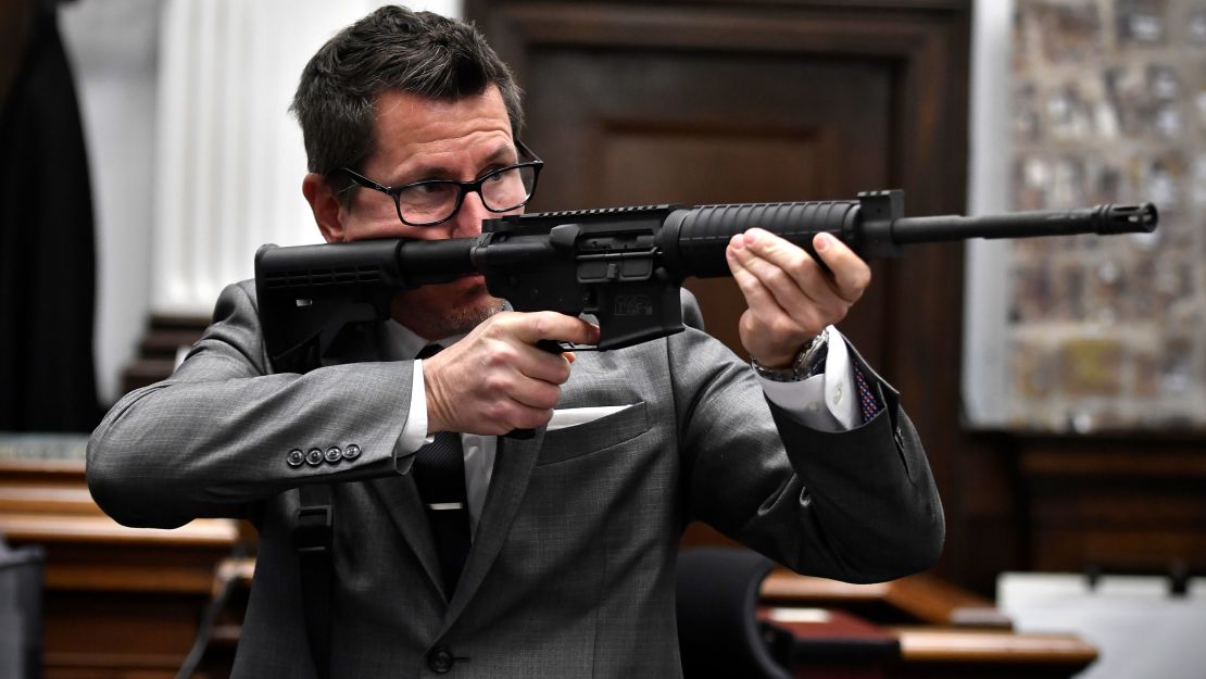 Assistant District Attorney Thomas Binger holds Kyle Rittenhouse's gun as he gives the state's closing argument on Monday, November 15.