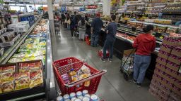 Customers stand in line to check out at a grocery store in San Francisco, California, U.S., on Thursday, Nov. 11, 2021. 