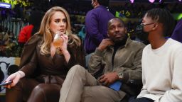 Singer Adele, left, and Rich Paul, center, attend an NBA basketball game between the Golden State Warriors and the Los Angeles Lakers in Los Angeles, Tuesday, Oct. 19, 2021. (AP Photo/Ringo H.W. Chiu)