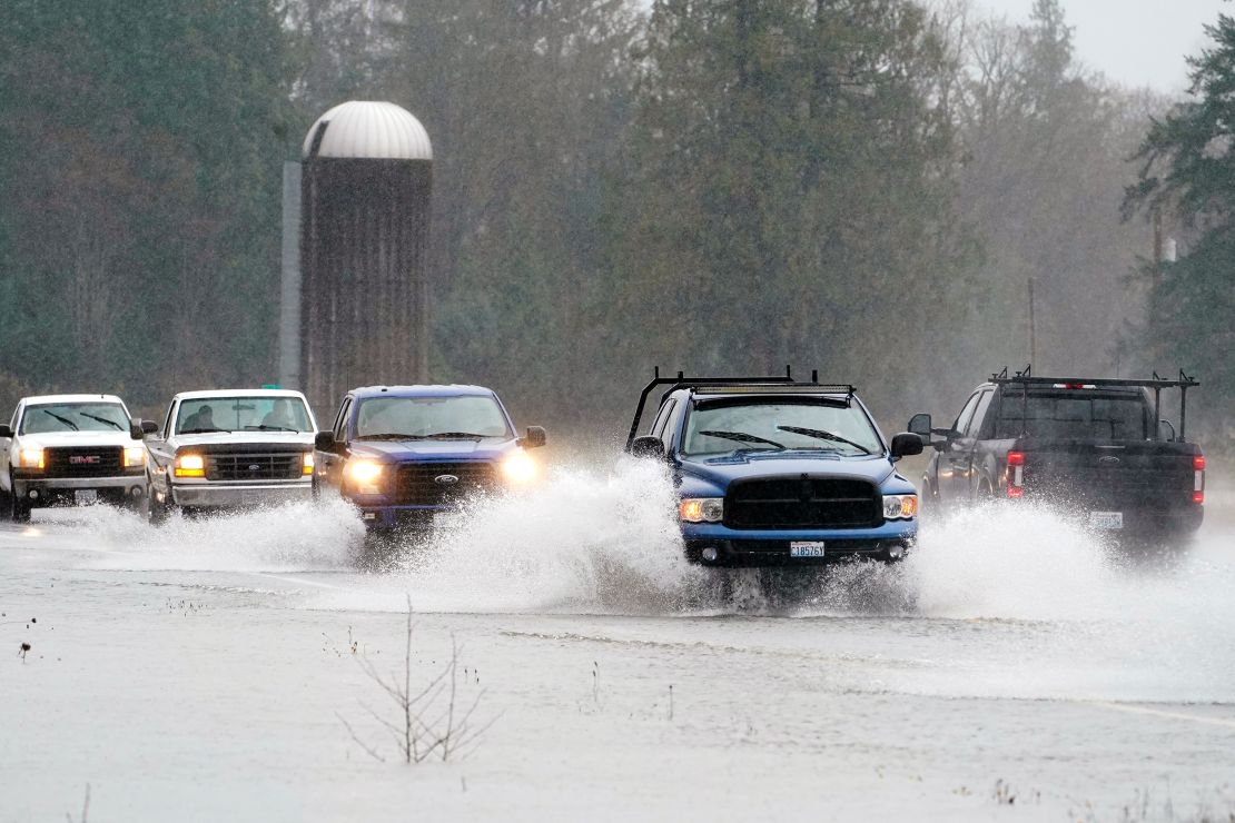 Traffic travels through water on Highway 20   near Hamilton, Washington, on Monday.