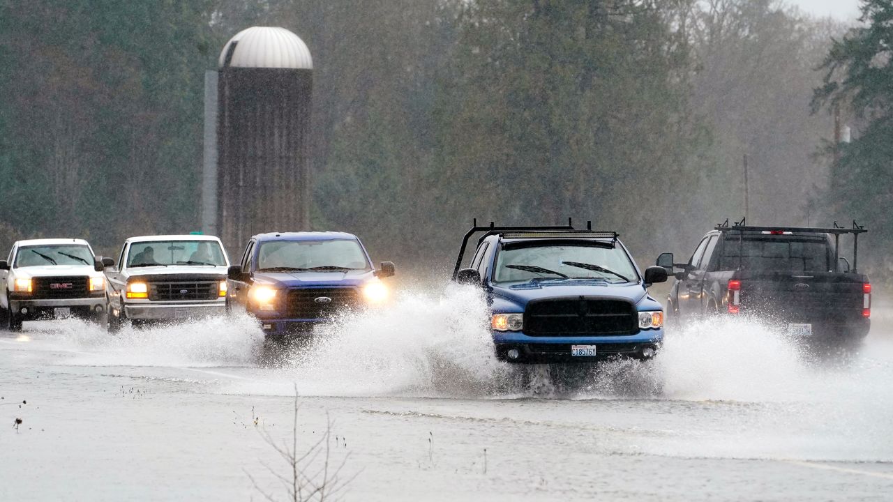 Traffic travels through water on Highway 20 near Hamilton, Washington, on Monday.