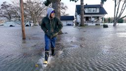 Benjamin Lopez steps from floodwater surrounding his parents home Monday, November 15, in Sedro-Woolley, Washington.