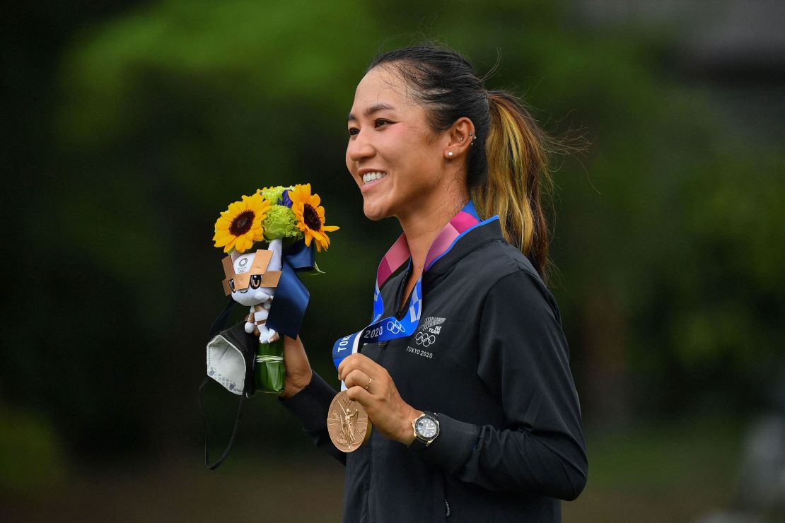 Ko poses with her bronze medal on the podium during the victory ceremony of the women's golf competition at the Tokyo 2020 Olympic Games.