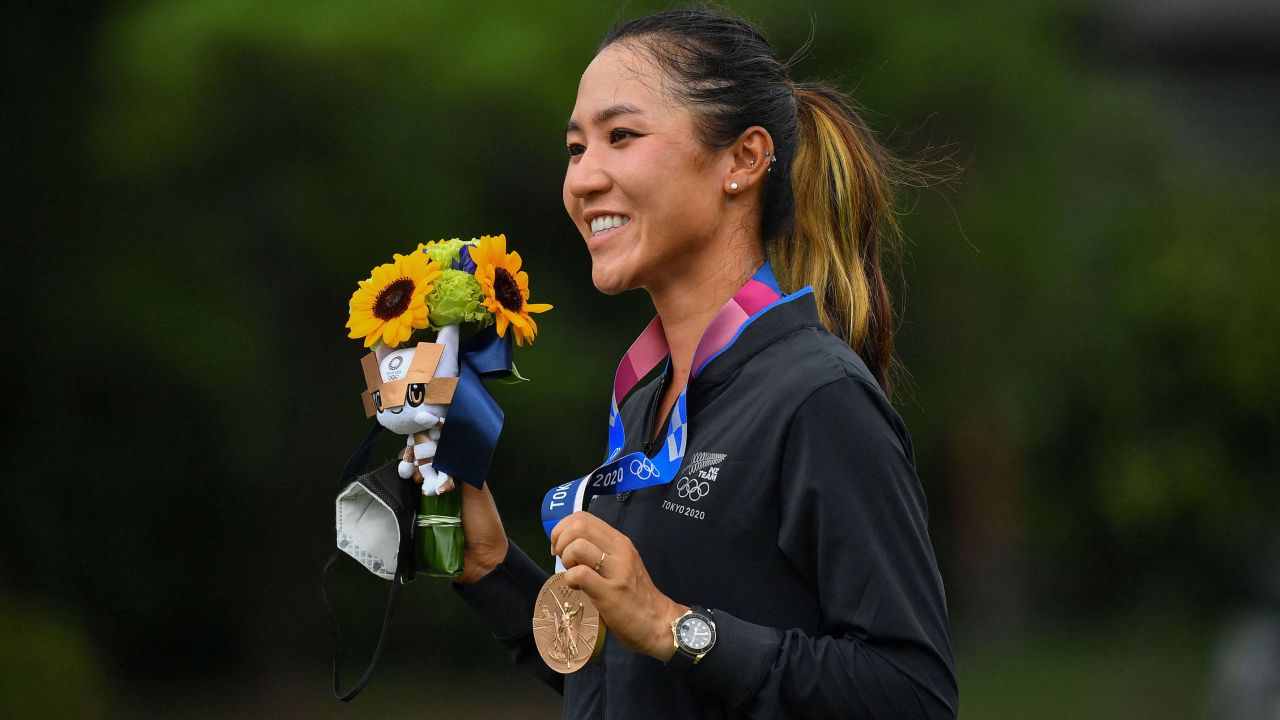 Ko poses with her bronze medal on the podium during the victory ceremony of the women's golf competition at the Tokyo 2020 Olympic Games.
