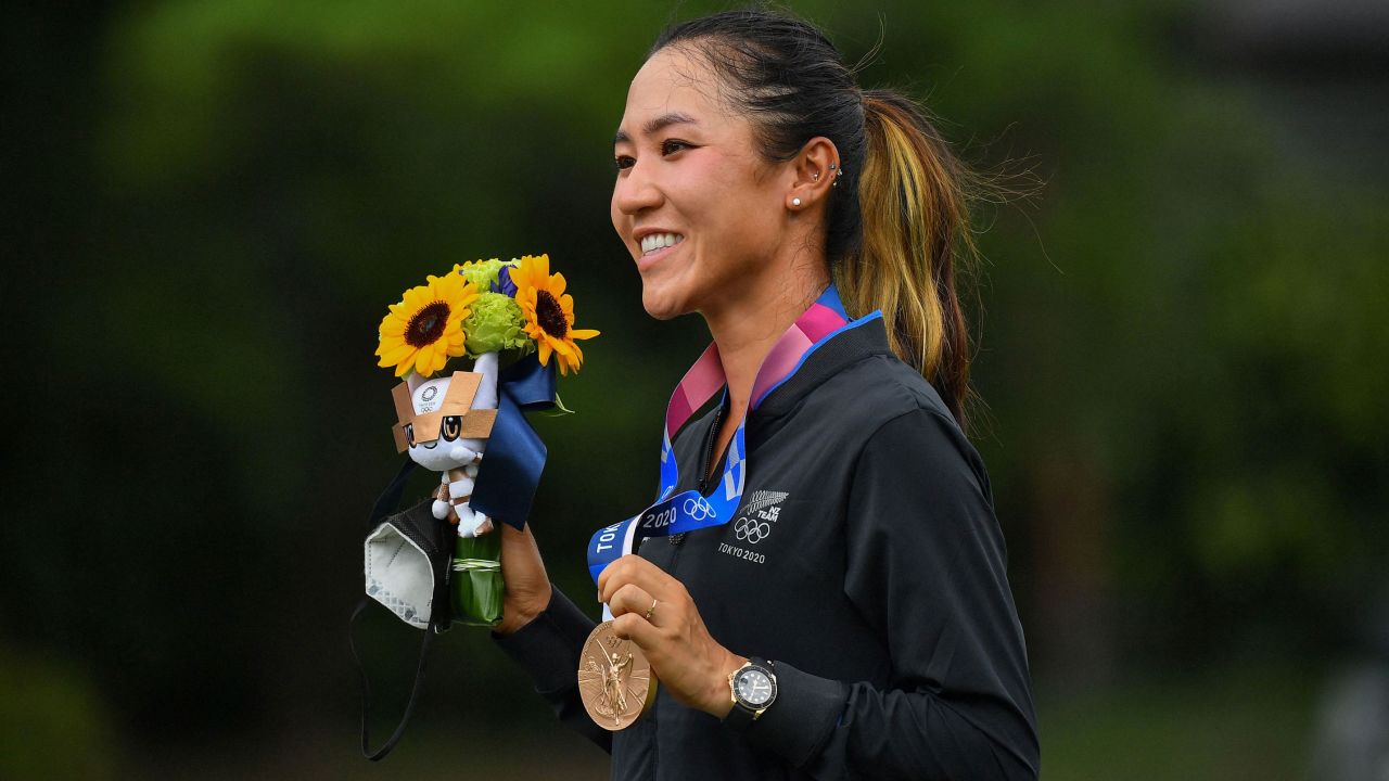 Ko poses with her bronze medal on the podium during the victory ceremony of the women's golf competition at the Tokyo 2020 Olympic Games.