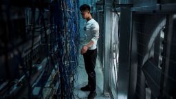 This photo taken on April 1, 2021 shows a worker adjusting cryptocurrency mining rigs at a cryptocurrency farm in Dujiangyan in China's southwestern Sichuan province.