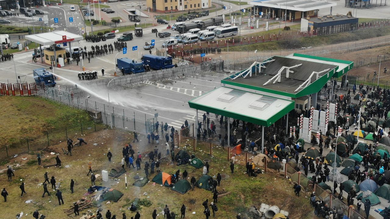 Polish law enforcement officers use a water cannon on migrants, who attempt to cross the Belarusian-Polish border at Bruzgi - Kuznica checkpoint in the Grodno region, Belarus on Nov. 16, 2021. Picture taken with a drone. 