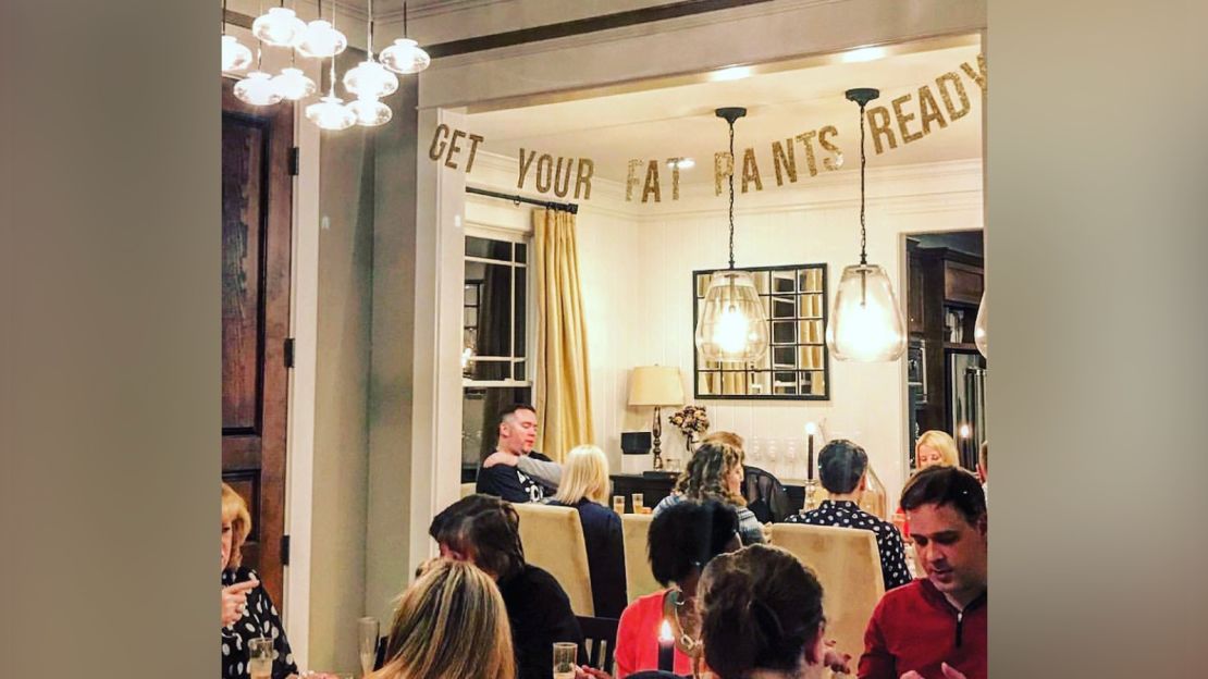 A "Get Your Fat Pants Ready" sign hangs during Thompson's annual Friendsgiving dinner.