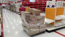A stocker drags a palate of boxes to place contents on empty shelves in a Target store in Lakewood, Colorado on Tuesday, Oct. 26, 2021.