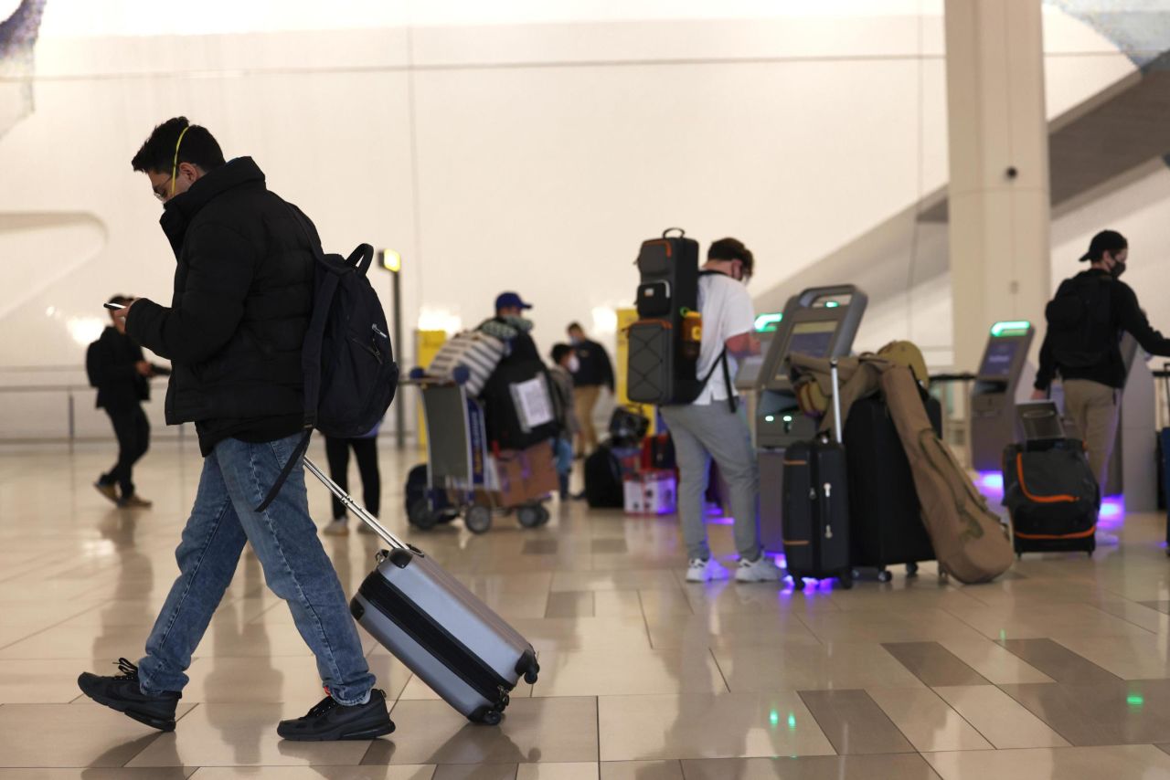 People check in for their flights at LaGuardia Airport on November 25, 2020.