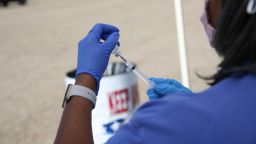 A healthcare worker prepares a flu shot during a drive-thru clinic at the Louisiana State Fairgrounds in Shreveport, Louisiana, U.S., on Thursday, Nov. 5, 2020. Shreveport recently completed a test run for distributing an eventual coronavirus vaccine, using a community drive-thru clinic for flu shots. Photographer: Dylan Hollingsworth/Bloomberg via Getty Images
