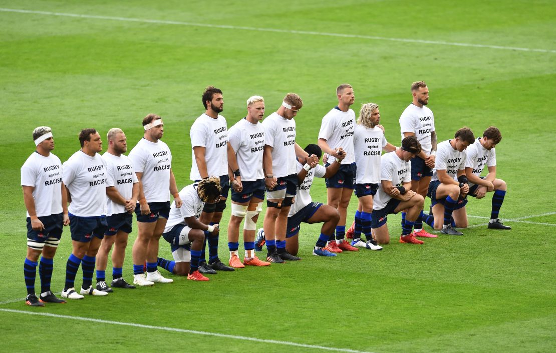 Some Sale Sharks players take a knee and some stand ahead of the side's game against Exeter last year.