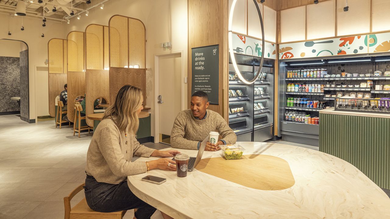 People sit at a table in the Starbucks Amazon Go store. 