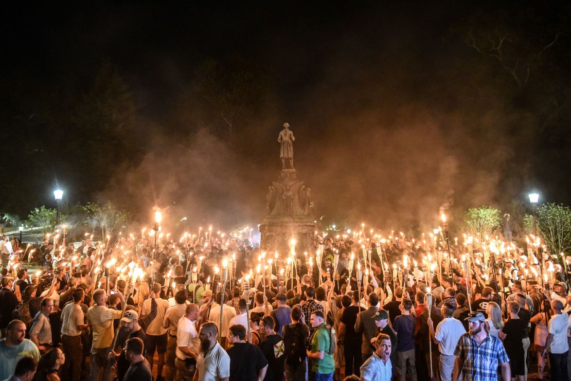 White nationalists participate in a march on the grounds of the University of Virginia ahead of the Unite the Right Rally in Charlottesville, Virginia, on August 11, 2017.