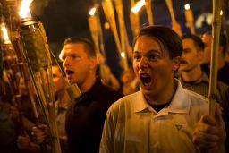 An alt-right activist in a polo shirt shouts during the torch march.