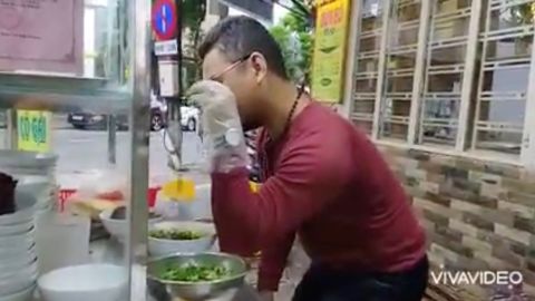 Bui Tuan Lam, 38, cooks at his beef noodle shop, in Da Nang, Vietnam on November 11, 2021, in this still image obtained from a social media video.