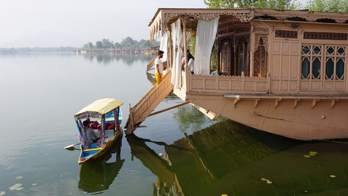 A shikara drops a passenger off at a houseboat moored on Srinagar's Nigeen Lake.    