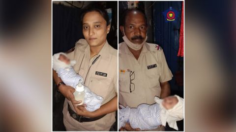 Mumbai Police hold a baby who was found in a drain in this image the police posted on twitter.