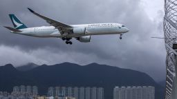 An aircraft operated by Cathay Pacific Airways Ltd. flies approaches Hong Kong International Airport in Hong Kong, China, on Tuesday, Aug. 10, 2021. Cathay is scheduled to report half-year results on Aug. 11. Photographer: Paul Yeung/Bloomberg via Getty Images