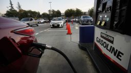 A driver pumps gas at a gas station of Costco in San Leandro, California on October 16, 2021.