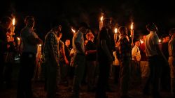 FILE - In this Aug. 11, 2017, file photo, multiple white nationalist groups march with torches through the University of Virginia campus in Charlottesville, Va. A federal judge has issued an arrest warrant for neo-Nazi podcaster Robert "Azzmador" Ray, who promoted and attended the white nationalist rally in Virginia that erupted in violence in 2017. (Mykal McEldowney/The Indianapolis Star via AP, File)