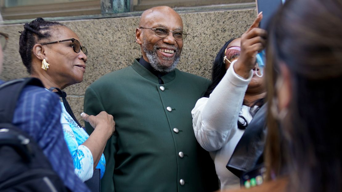 Muhammad Aziz, center, poses for photos outside the courthouse in New York with members of his family after his conviction in the killing of Malcolm X was vacated on Thursday, November 18.