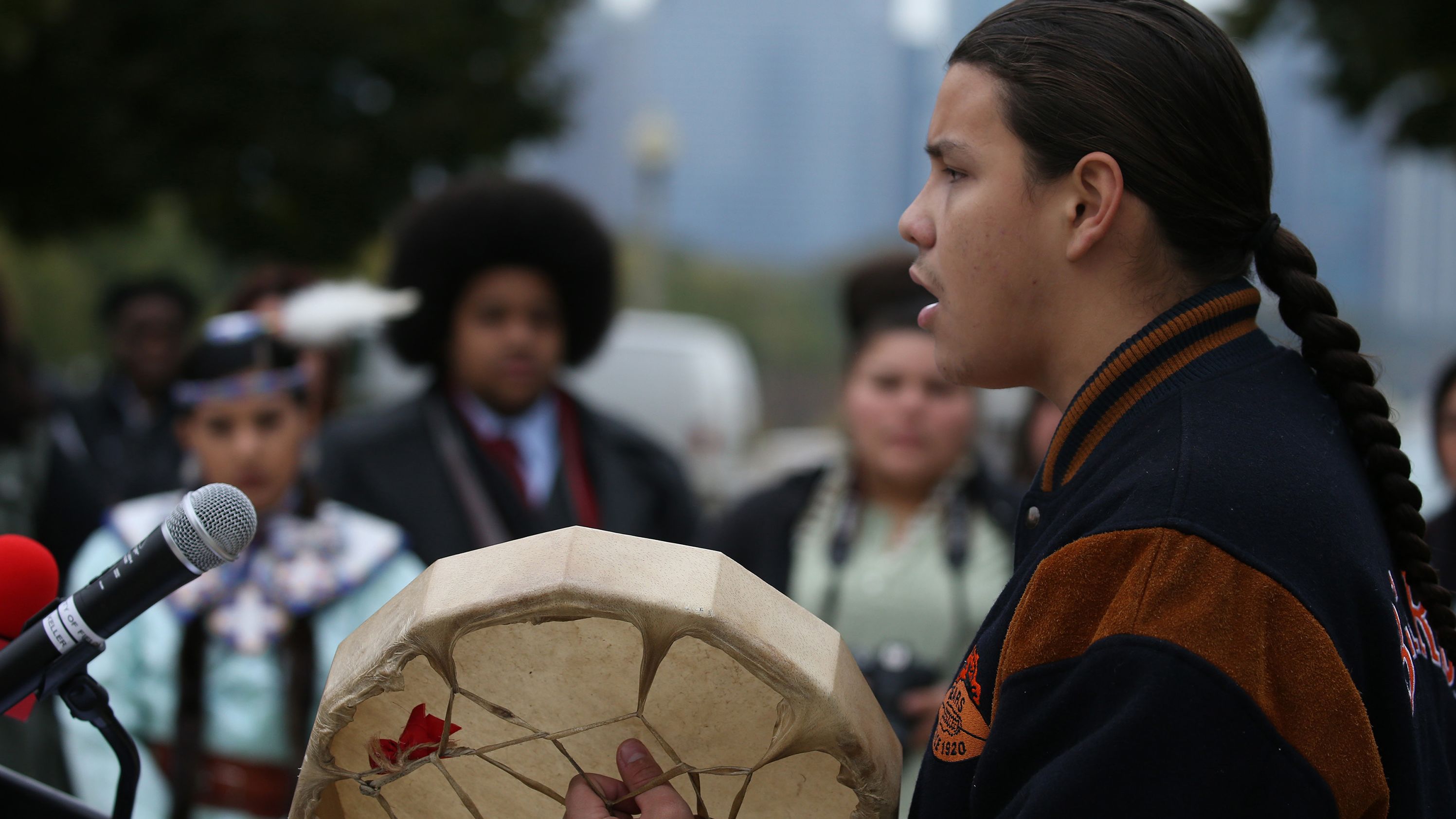 Adrien Pochel, who is Oji-Cree and Lakota, drums and sings during a land acknowledgement ceremony for Chicago's Field Museum on October 26, 2018.